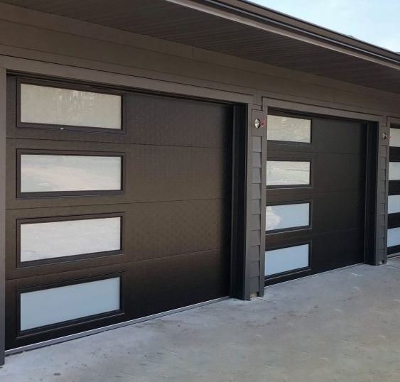 These Clopay Modern Steel garage doors feature a mocha finish and contemporary slim windows arranged vertically.