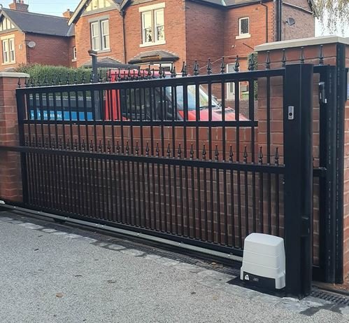 This is a modern metal cantilever sliding gate featuring vertical bars and a black powder-coated finish.
